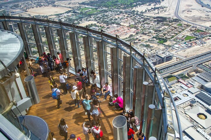 Experience stunning views from the Burj Khalifa observation deck while enjoying the lively energy of fellow travelers. Witness Dubai's skyline and the beauty below capturing unforgettable moments.